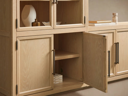 Hattie Glass Media Cabinet: Light oak wall-mounted system with arched glass doors on upper cabinets, solid lower doors, dark pulls.