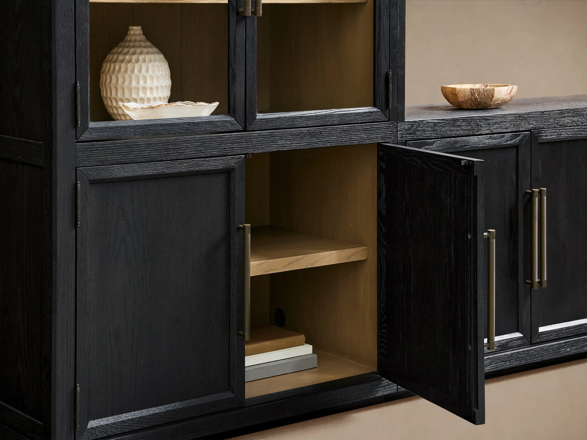 Hattie Glass Media Cabinet: Dark oak media unit with two arched glass-door cabinets, long base, reeded pulls, against beige wall.