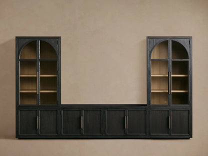 Close-up of Hattie Glass Media Cabinet, dark black oak with visible grain. Lower door open shows light wood interior shelf. Antiqued bronze hardware.