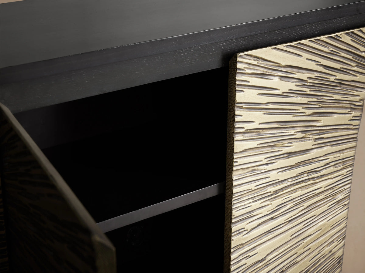 Helios Sideboard with ebony-stained frame and four doors featuring brass sheeting in a sunburst pattern, on wooden floor.