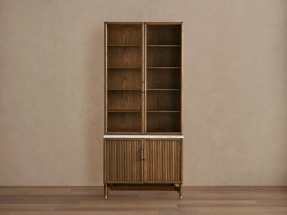 Henderson Cabinet with wood frame in honey finish, black accents, glass doors, adjustable shelves, and Italian Carrara marble top.
