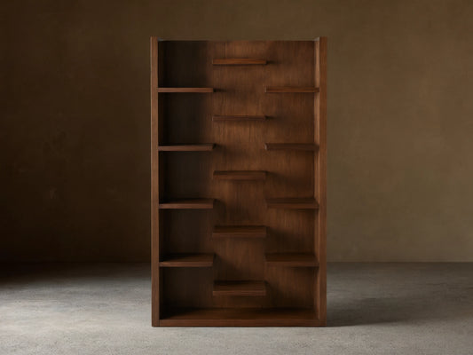 James Bookcase with walnut finish, featuring 13 asymmetrically arranged floating shelves, displayed against a neutral background.
