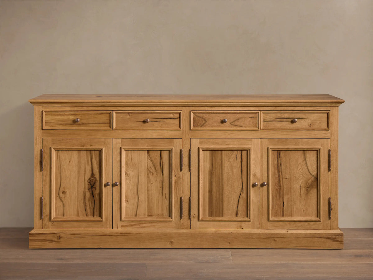 Front view of the Kensington Reclaimed Buffet, natural reclaimed French oak wood, with four drawers and four cabinet doors, antique brass pulls.