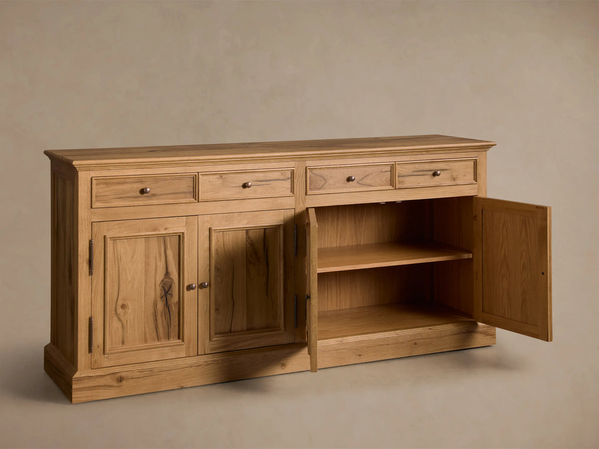Front view of the Kensington Reclaimed Buffet, natural reclaimed French oak wood, with four drawers and four cabinet doors, antique brass pulls.