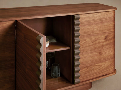 Dark walnut Ribbon Sideboard with two right doors open showing lighter wood shelves inside. Features wavy, bronze-toned ribbon pulls.