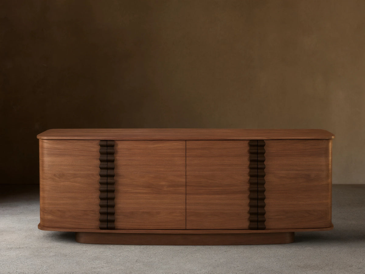 Walnut Ribbon Sideboard with rounded corners, featuring four doors and dark sculptural ribbon pulls.