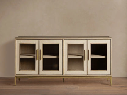 Elegant Malone Sideboard in light wood, featuring 4 glass doors with gold bar handles, metallic base, and visible shelves.