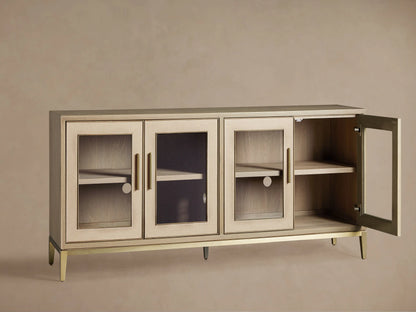 Close-up of Malone Sideboard with glass door, light wood shelves, brass handle & trim, and textured cream shagreen frame.