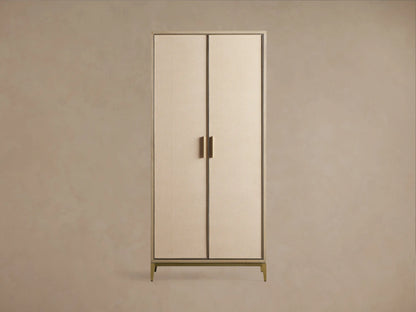 Close-up of Malone Cabinet: two light beige doors with textured shagreen insets, light wood frame, and sleek gold metallic legs.