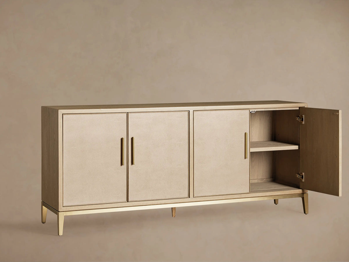 Malone Sideboard's light oak veneer interior, showing two shelves, cable holes, an open door with hinge, and a brass base.
