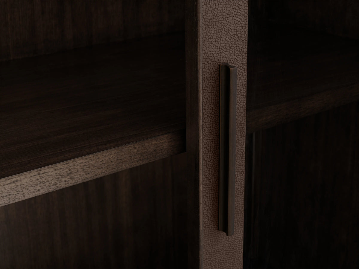 Malone Glass Cabinet in dark walnut finish with dual tempered glass doors, three shelves, and metallic handles, against a beige wall.