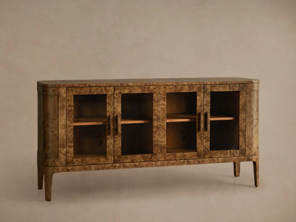 Front view of Mappa burl wood Mogadore Sideboard with four glass doors, antique brass handles, two interior shelves, and tapered legs.