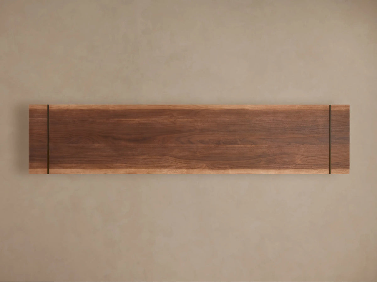 Close-up of Mihaela Media Console in Walnut, with an open door revealing shelves holding a gray vase and books.