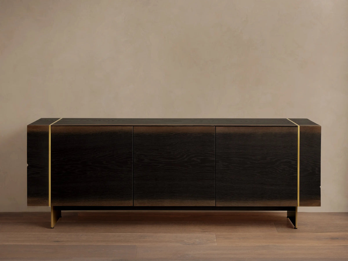 Mihaela Media Console: Dark walnut veneer, three doors, visible wood grain, metallic gold accents, dark angled metal legs.