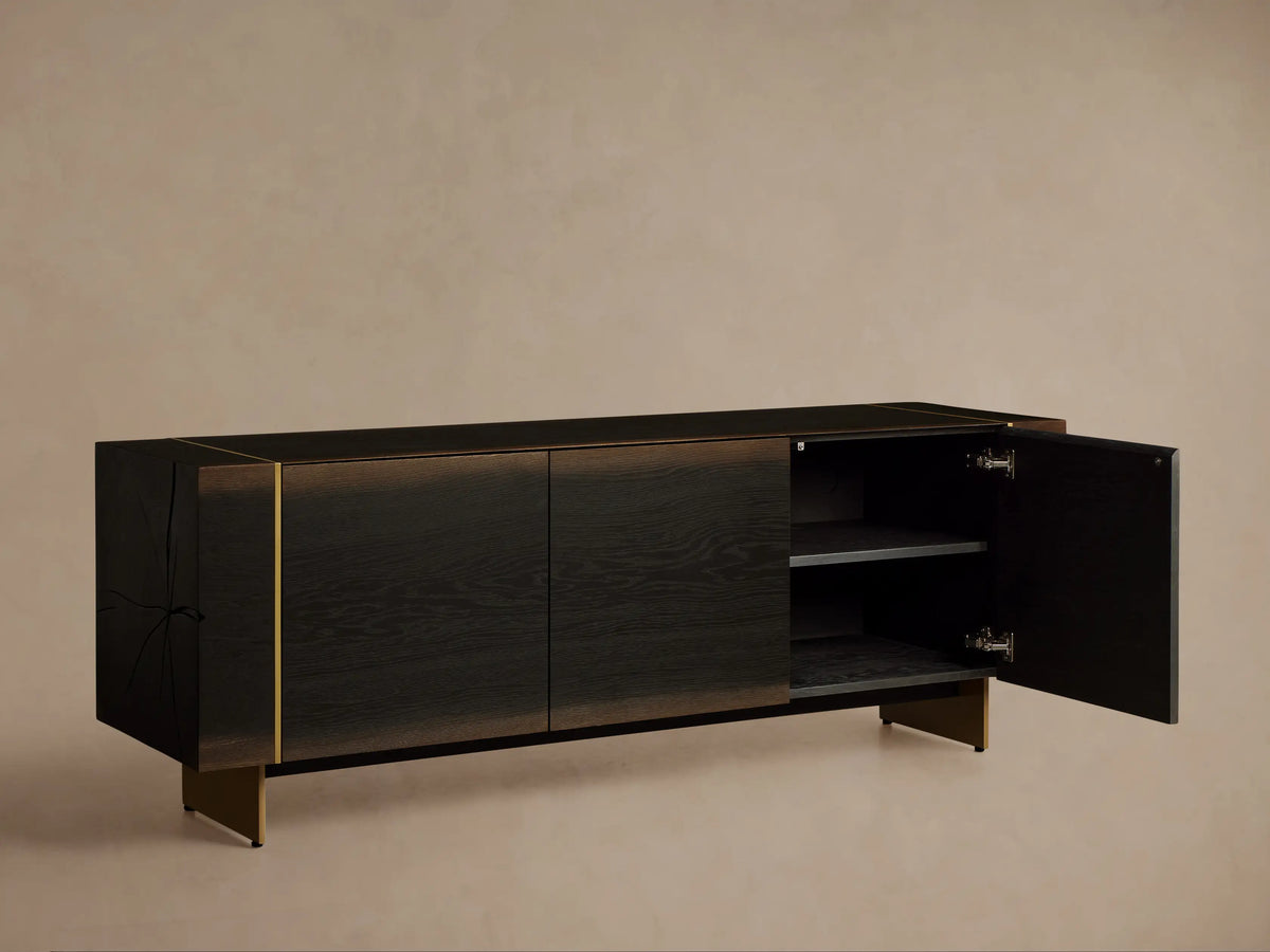 Mihaela Media Console: Dark walnut veneer, three doors, visible wood grain, metallic gold accents, dark angled metal legs.