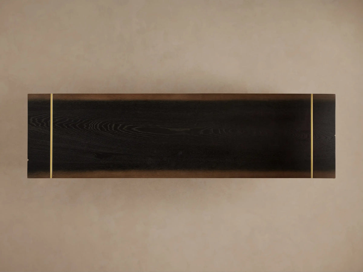 Dark walnut Mihaela Media Console with unique radial end grain, gold trim, open cabinet revealing shelves & decor, on golden metal legs.