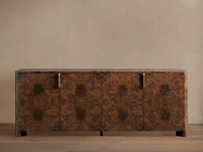 Morley Sideboard with swirling walnut burl wood veneer, auburn tone finish, four cabinet doors, and brass-finished pulls.
