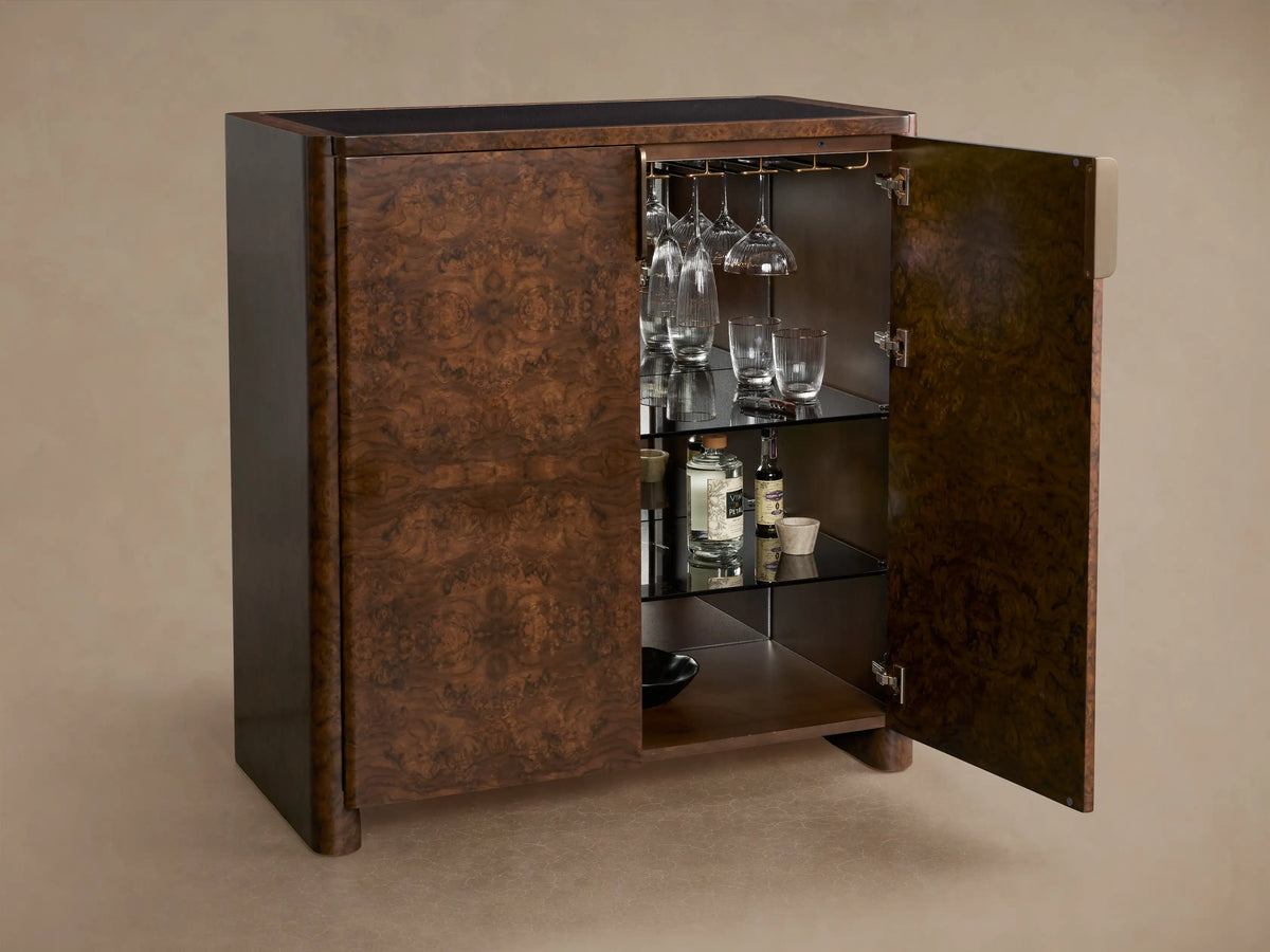 Morley Bar Cabinet with a rich dark brown wood finish, intricate grain pattern, sleek black top, and single vertical handle.