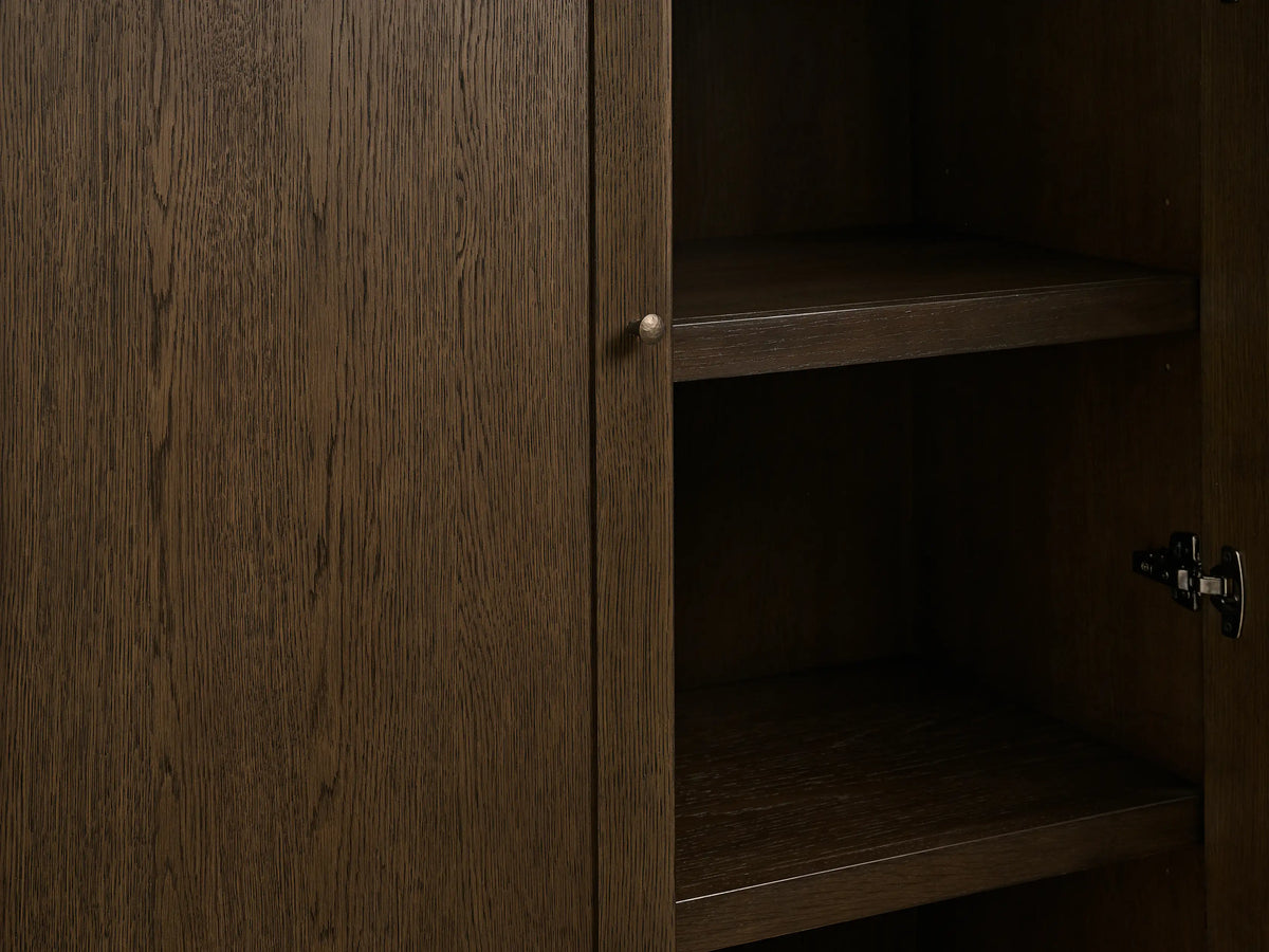 Dark mocha red oak Nason Modular Hutch Cabinet, left door closed, right open with two shelves and a visible soft-close hinge.