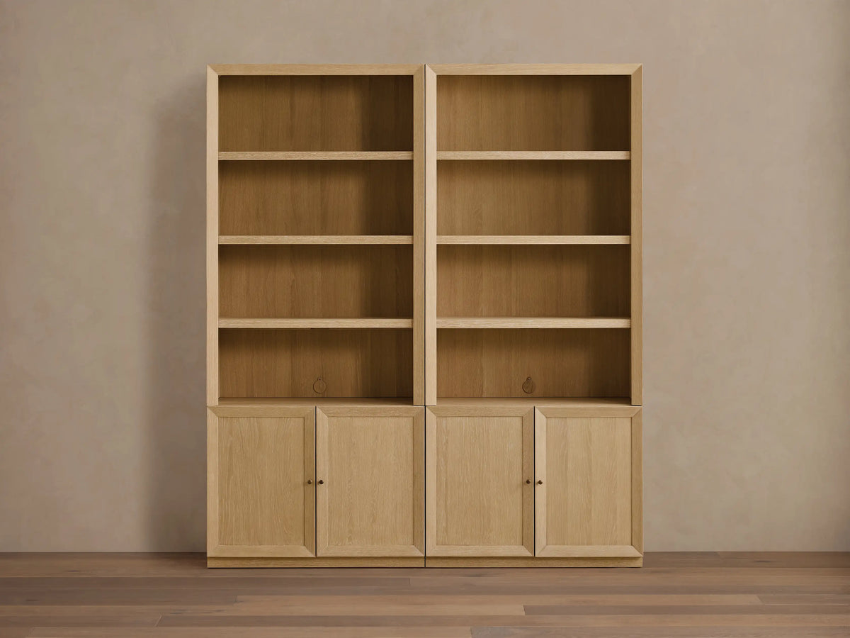 Side-by-side Nason Modular Hutch Cabinets in light sand oak. Each has open shelves above two base cabinets with aged nickel pulls.