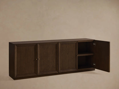 Nason Modular Four-Door Media Base in Mocha finish, featuring four paneled doors with small metal handles, on a wood floor.