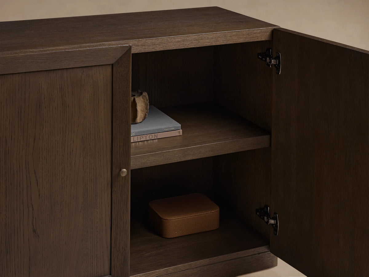 Nason Modular Four-Door Media Base in dark mocha red oak. One door is open, showing two shelves inside. Mitered door frames.