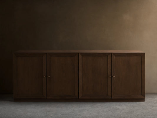 Nason Modular Four-Door Media Base in Mocha finish, featuring four paneled doors with small metal handles, on a wood floor.