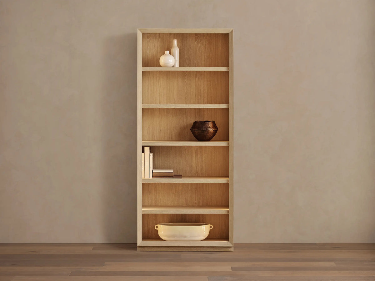 Nason Modular Bookcase in sand white oak, with 6 shelves, recessed LED lighting, and decorative items on display.
