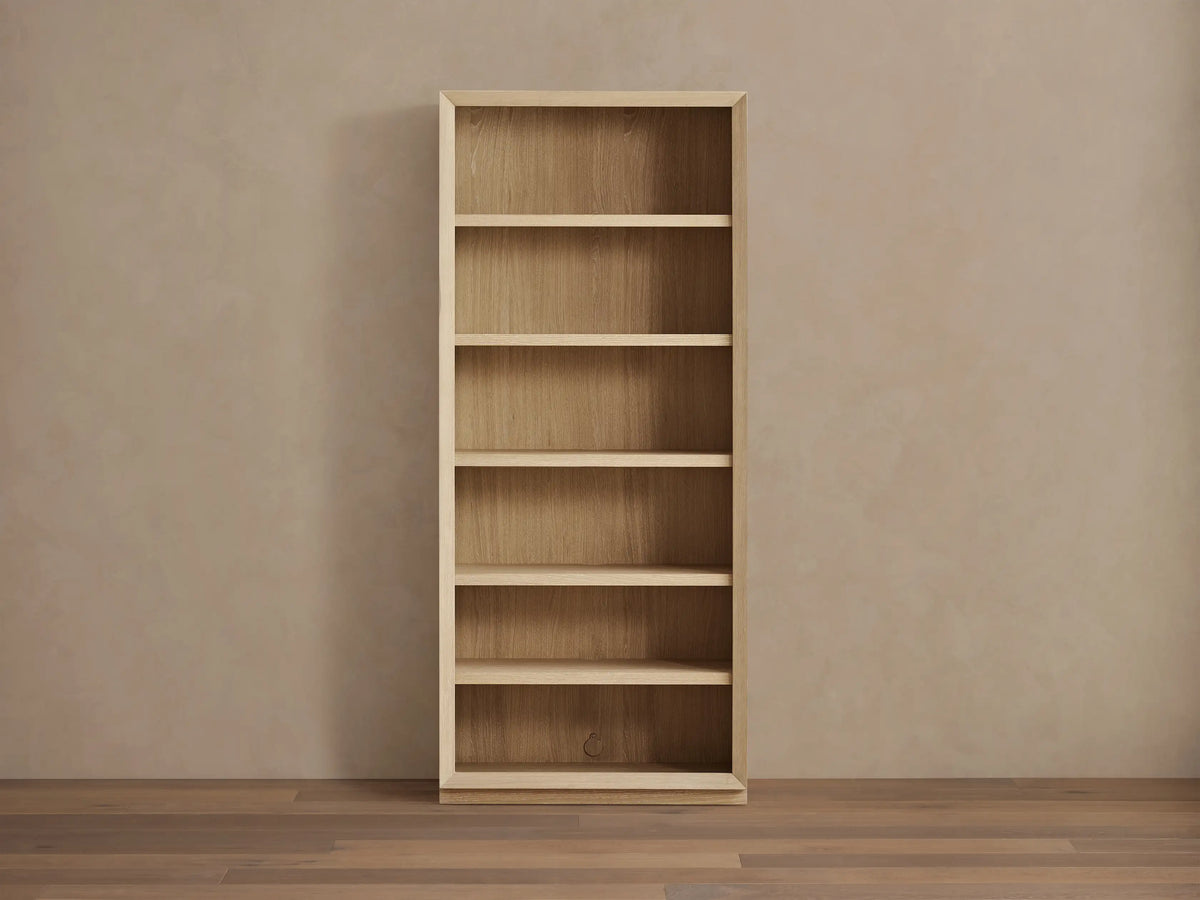 Nason Modular Bookcase in sand white oak, with 6 shelves, recessed LED lighting, and decorative items on display.
