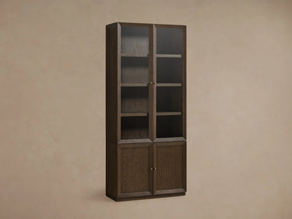 Nason Modular Glass Cabinet in dark Mocha finish. Tall unit with glass display tops, solid doors below, shelves, and decor items.