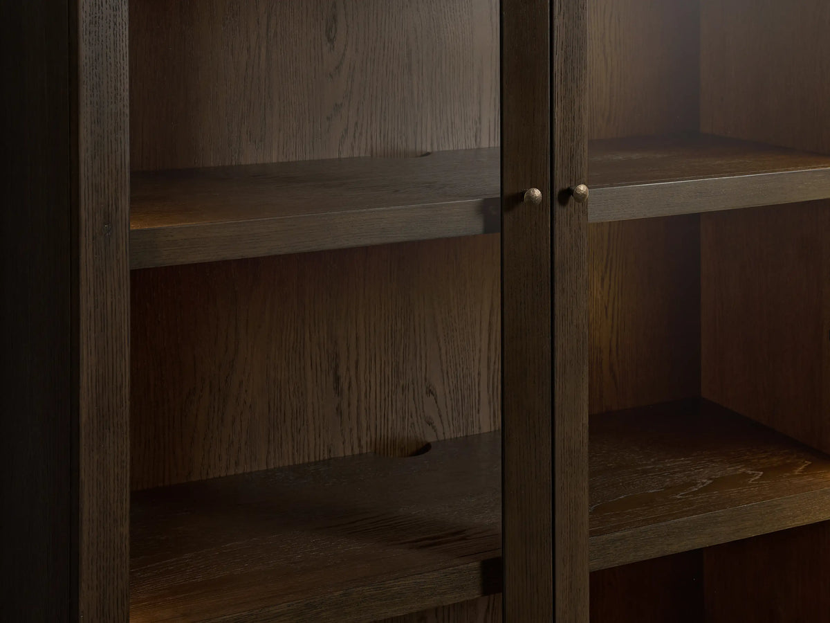 Dark mocha Nason Modular Glass Cabinet. Tall wood cabinet with two glass top doors and two solid bottom doors, aged nickel handles.