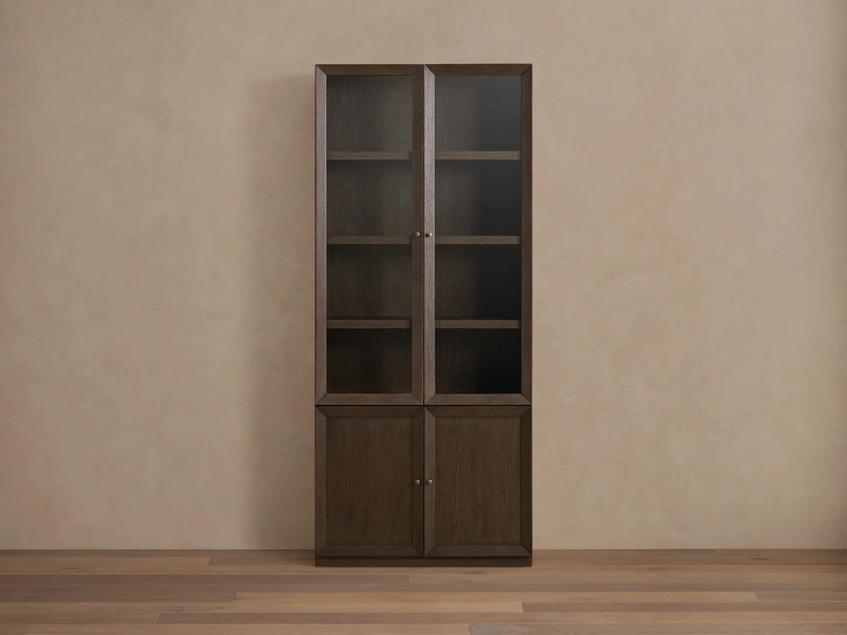Nason Modular Glass Cabinet, dark mocha oak finish, with door partially open revealing interior shelf & aged nickel knob.