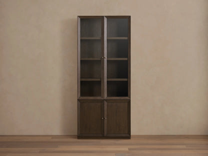 Nason Modular Glass Cabinet, dark mocha oak finish, with door partially open revealing interior shelf & aged nickel knob.