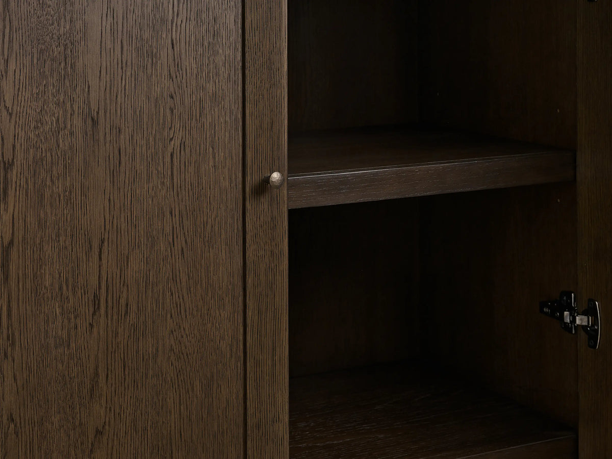 Nason Modular Hutch Cabinet close-up. Dark mocha oak door with prominent grain, aged nickel handle, interior shelf, and hinge.