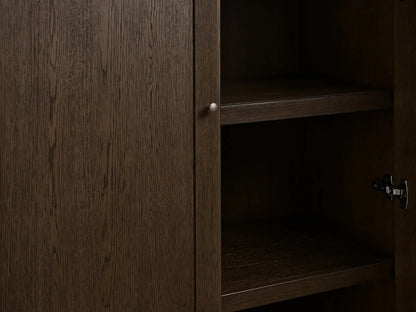 Nason Modular Hutch Cabinet in Mocha red oak. Close-up of left door with aged nickel knob, right open showing dark shelves.