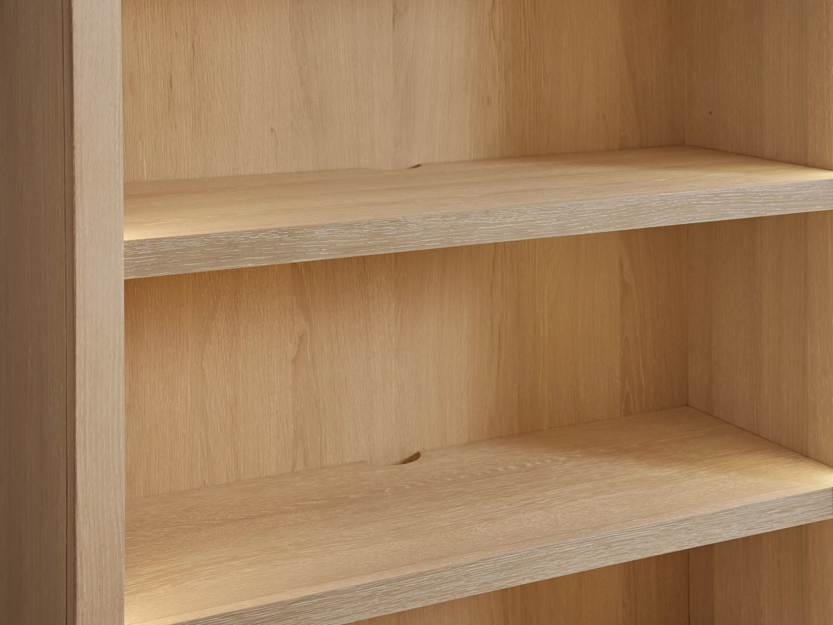 Close-up of Nason Modular Hutch Cabinet in sand white oak, showing two empty shelves with visible wood grain and soft lighting.
