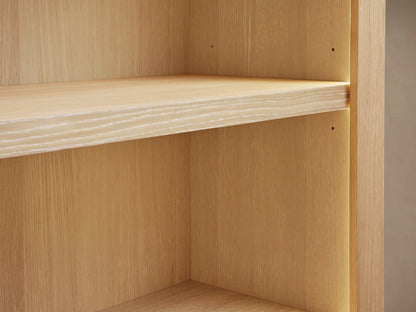 Close-up of Nason Modular Hutch Cabinet's light white oak shelf with visible grain, illuminated by soft warm light from the right.
