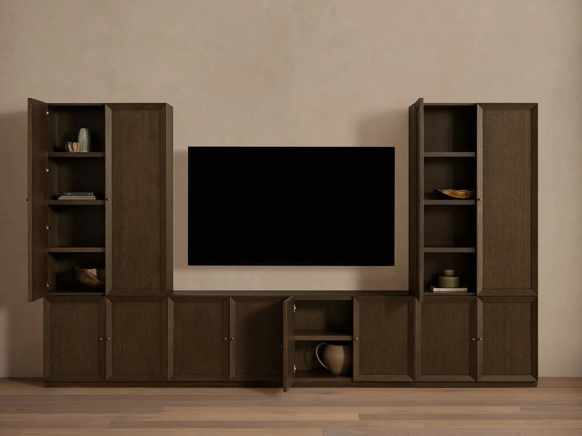Mocha finished Nason Modular Media Cabinet Set. Dark oak units with framed doors, some open revealing shelves and decor, flanking a TV.