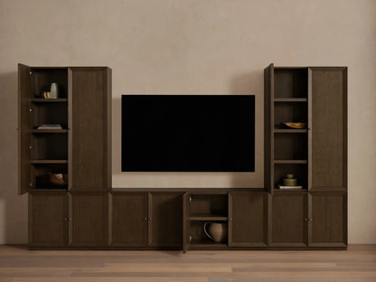 Mocha finished Nason Modular Media Cabinet Set. Dark oak units with framed doors, some open revealing shelves and decor, flanking a TV.