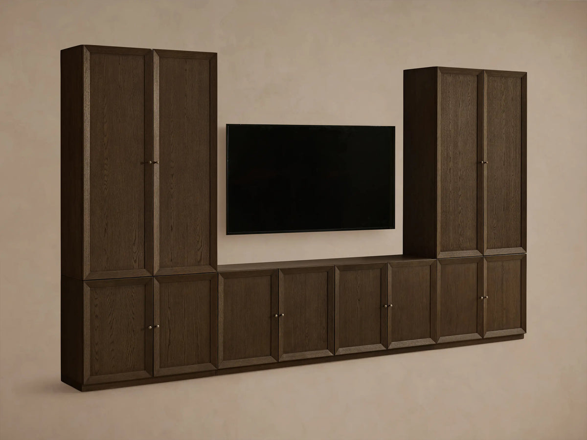 Mocha finished Nason Modular Media Cabinet Set. Dark oak units with framed doors, some open revealing shelves and decor, flanking a TV.
