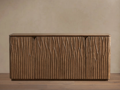 Norris Sideboard: Medium brown wooden sideboard with a flat top and four doors displaying a distinct wavy carved vertical pattern.