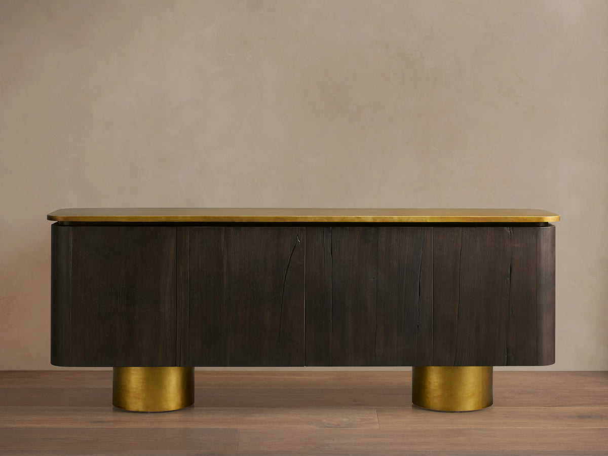 Neira Buffet crafted from Mexican walnut wood with a dark ash finish, features aged brass legs and top; four-door design.