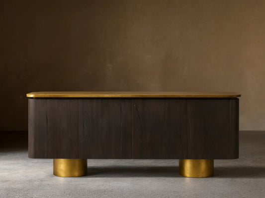 Neira Buffet crafted from Mexican walnut wood with a dark ash finish, features aged brass legs and top; four-door design.