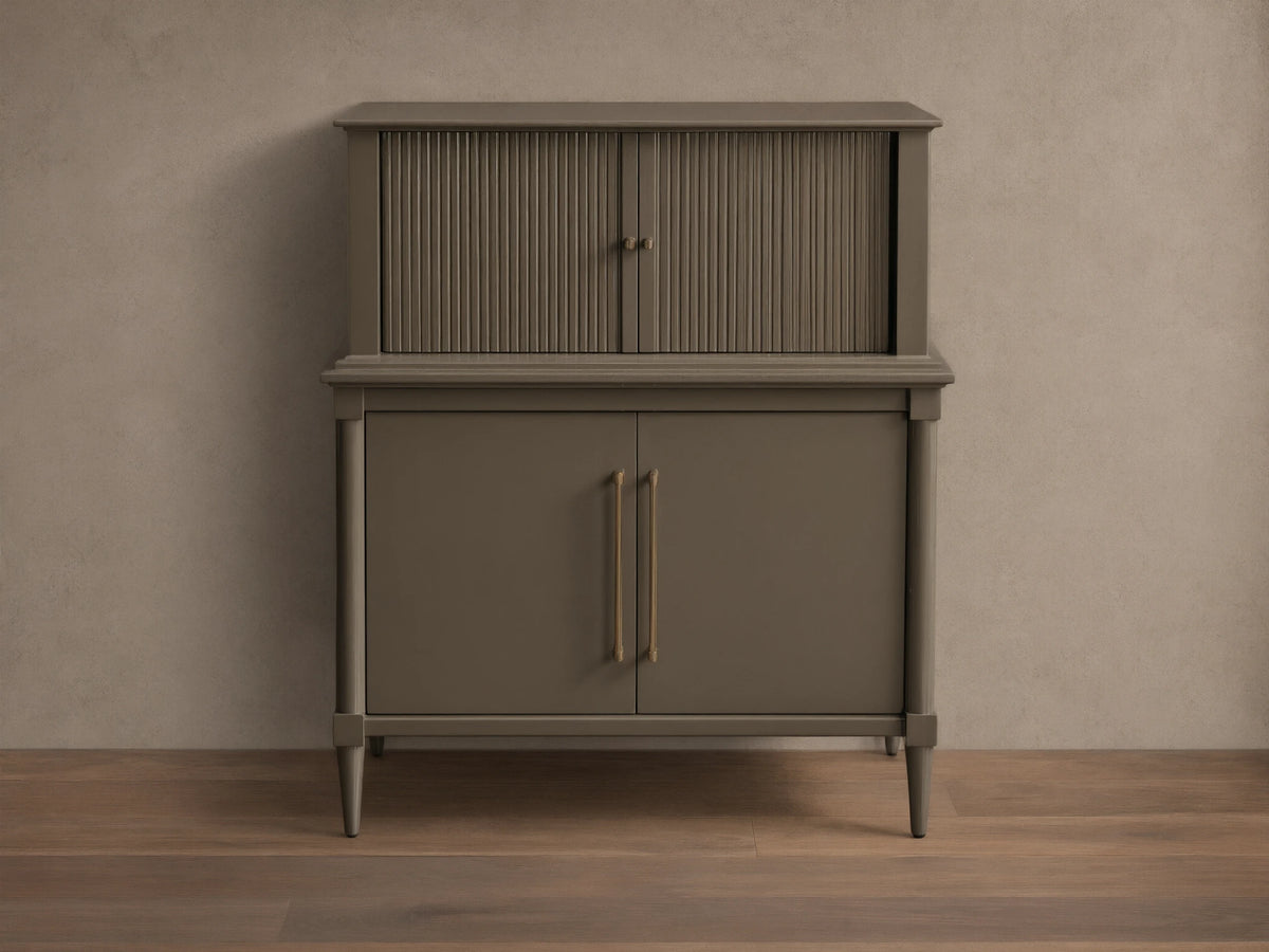 Front view of the dark gray-green Oakleigh Bar Cabinet, featuring reeded upper doors, solid lower doors, and brass pulls.