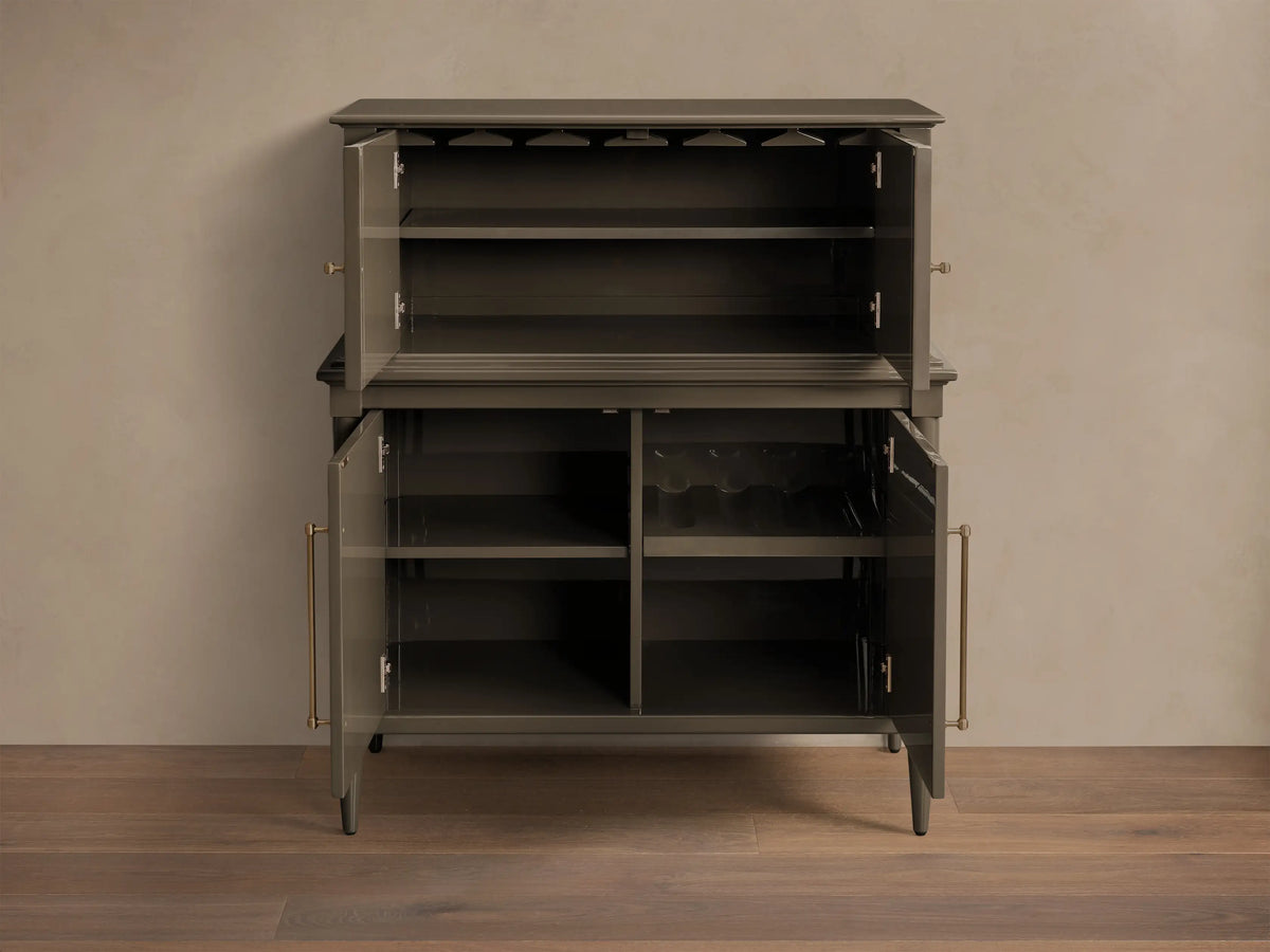 Front view of the Deep gray Oakleigh Bar Cabinet with open doors, revealing stemware racks, bottle storage, and brass hardware.