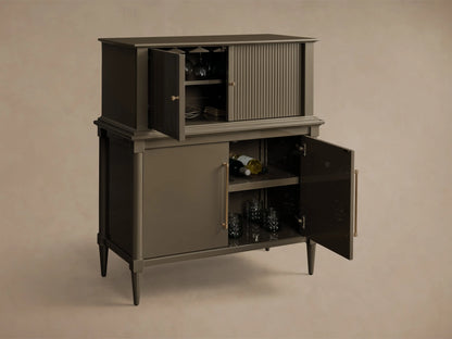 Front view of deep taupe Oakleigh Bar Cabinet with open reeded upper door showing stemware, and open lower door revealing wine and glasses.