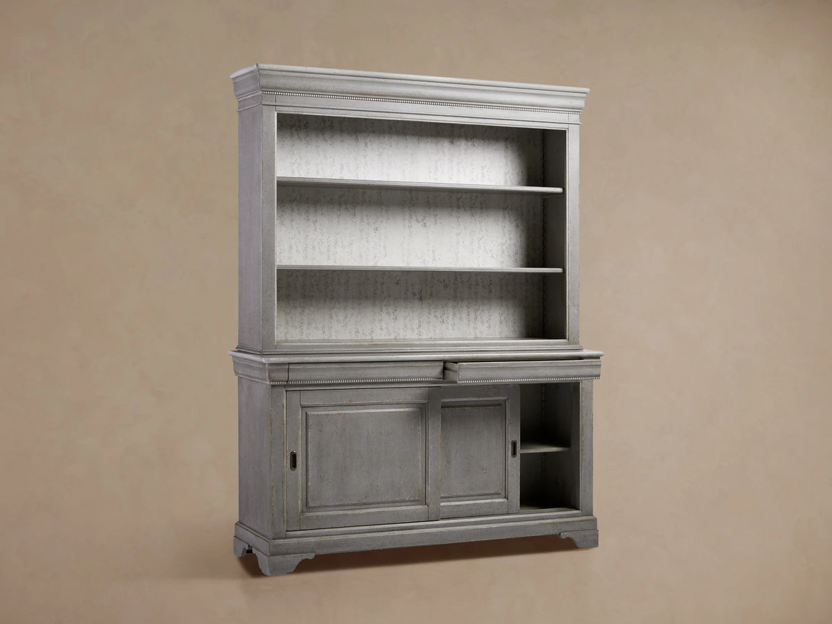 Antique grey bookcase crafted from tulip wood, featuring three open shelves above, a drawer, and closed cabinet doors below.