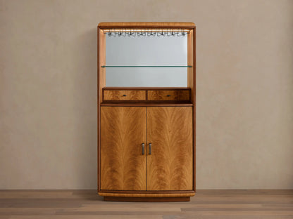 Front view of the Palma Bar, a wood bar cabinet with prominent cerajeira veneer graining, mirrored back, glass shelf, and LED lighting.