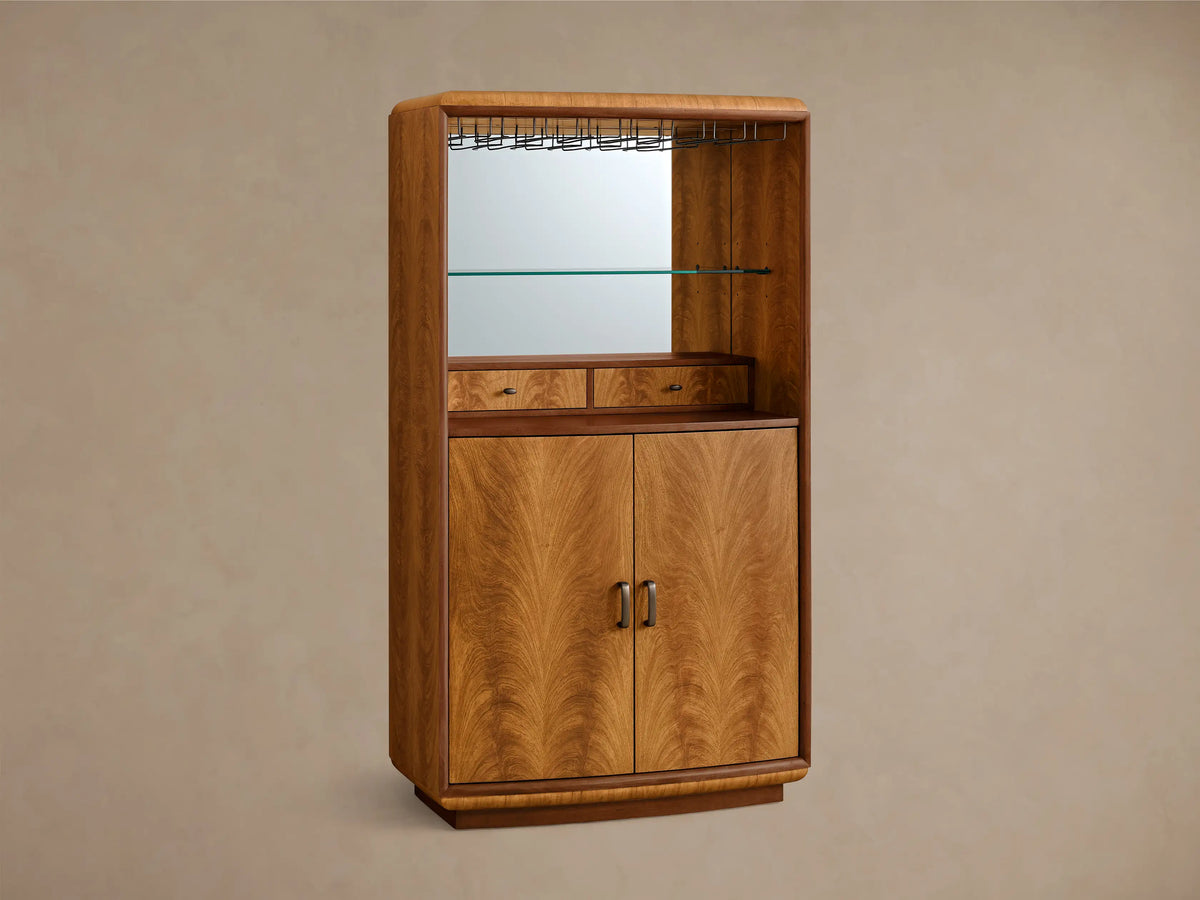 Front view of the Palma Bar, a wood bar cabinet with prominent cerajeira veneer graining, mirrored back, glass shelf, and LED lighting.