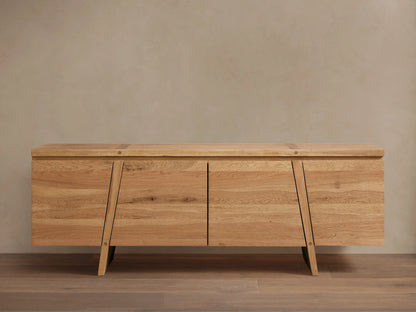 Panta Sideboard in light wood finish with four doors, angled side legs, and a flat top, set against a neutral wall.